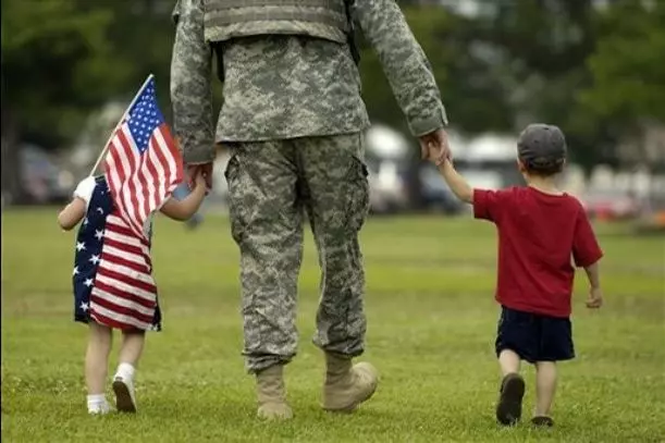 A us military man with his two kids walking